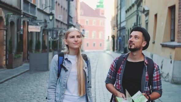 Happy Couple of Tourists with Map Walking on Central Street of Old European City