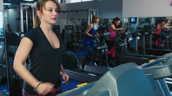 Attractive Woman Walking On a Treadmill