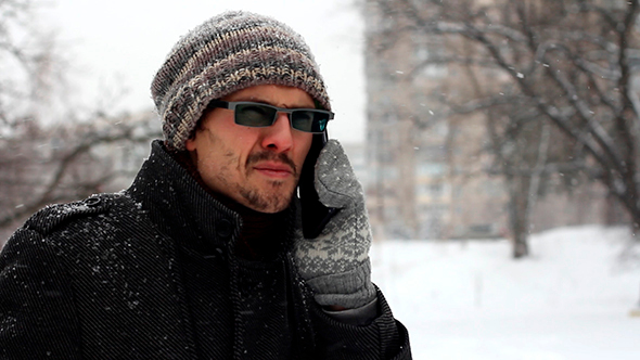 Man Talking On The Phone Outdoors In Winter alt
