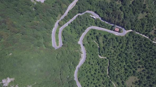 Aerial view of a winding mountain road in Italy