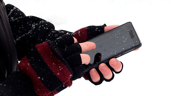 Man Uses a Phone Winter