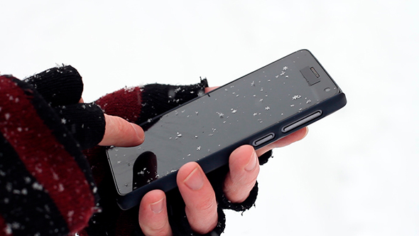 Man Uses a Mobile Winter