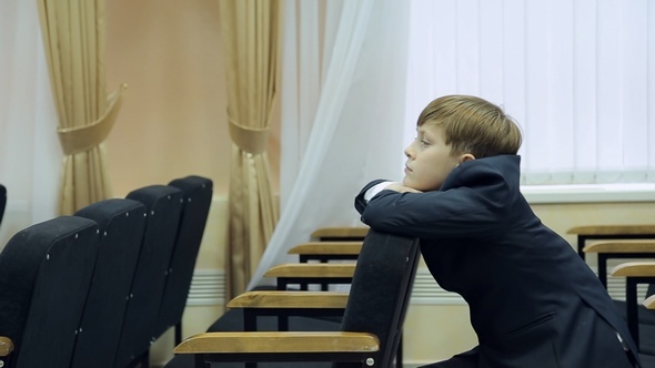 Boy Pupil Sits Pensively on the Couch