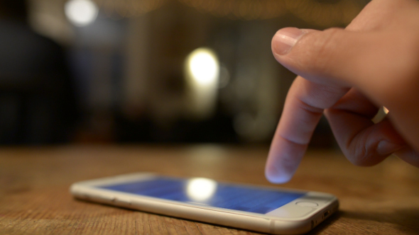 Text Messaging on Phone at Night on Table