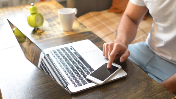 Casual Man Using Tablet on Table