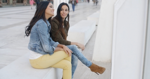 Two Trendy Young Women Relaxing alt