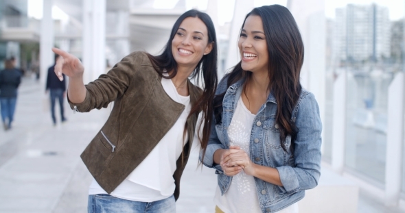 Trendy Young Woman Pointing At Something alt