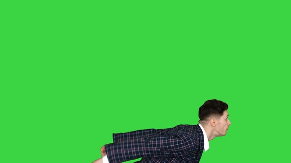 Businessman Makes a Back Flip and Shows Cool Gesture To Camera After on a Green Screen, Chroma Key