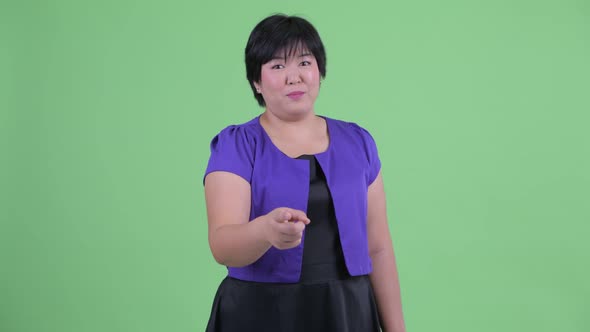Happy Young Beautiful Overweight Asian Woman Pointing at Camera