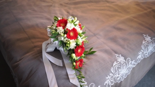 Wedding Bouquet On Bed