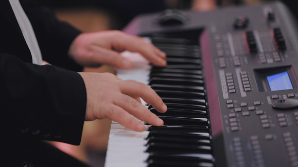 Musician Plays a Synthesizer