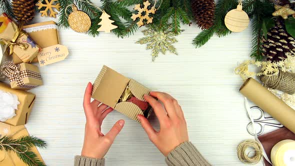 Woman hands packing gift