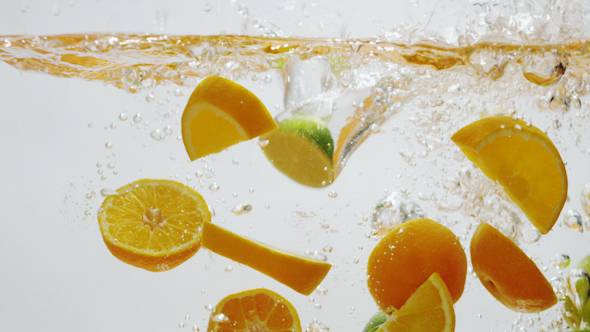 Oranges and Limes Falling into Water