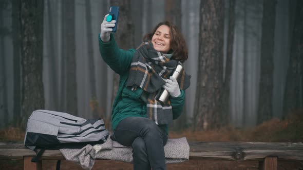  Young Cheerful Woman Taking a Selfie on Her Smartphone in a Misty Autumn Forest