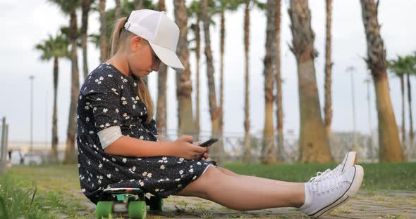 Girl Riding on Skateboard in Tropical Park