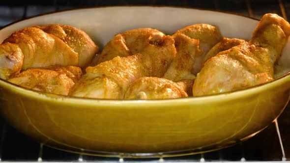 Cooking chicken leg drumstick in an oven bowl, baking process