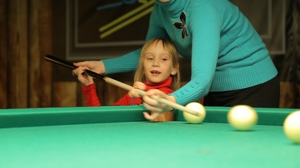 Girl with Mom Plays Billiards