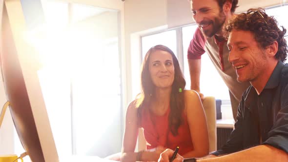 Group of graphic designers interacting while working