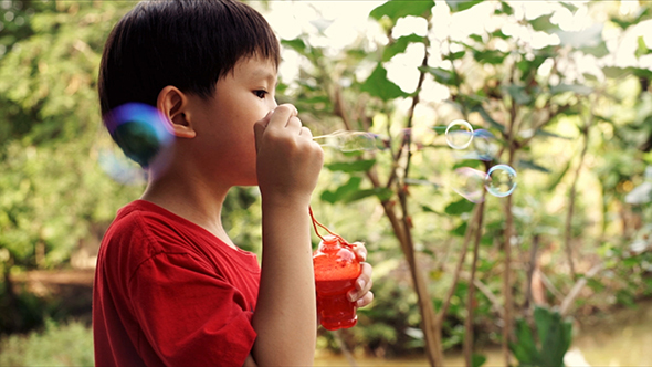 Young Boy Blowing Soap Bubbles 02