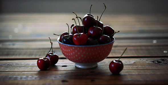 Red Ripe Cherries In Small Bowl On Wooden Table