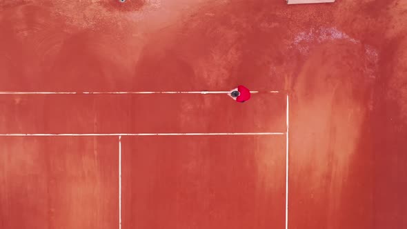 A Man is Marking the Tennis Court in a View From Above