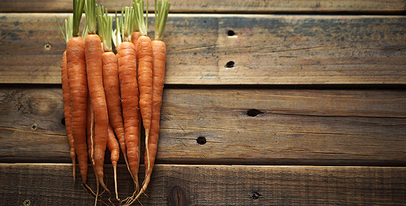 Placing A Baby Carrot On A Bunch Of Carrots