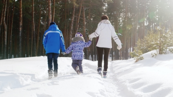 Family On Walk In The Winter Forest