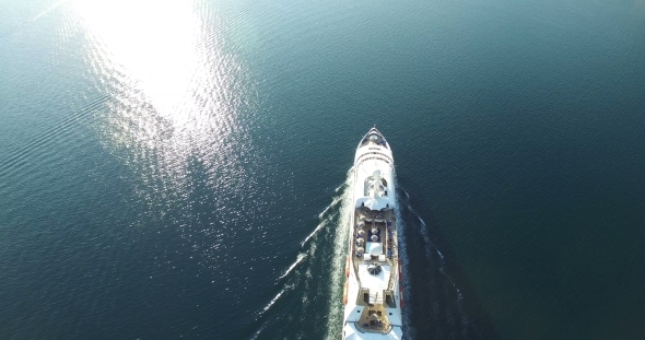 Aerial View Of Luxury Medium Cruise Ship Sailing From Port On Sunrise
