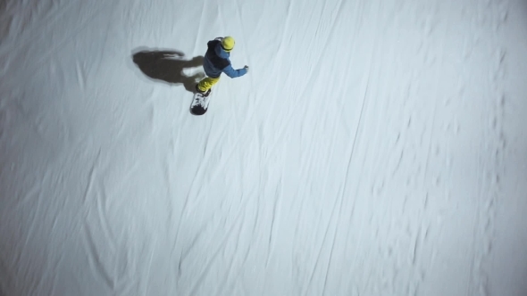 Aerial Shot Snowboarder Slides Down The Mountain Via The Springboard
