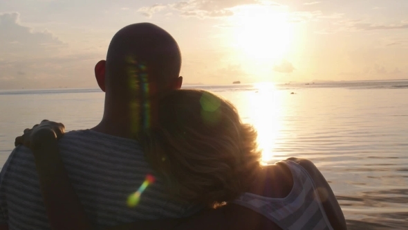 Young Couple In Love Hugging At Sunset On Beach 