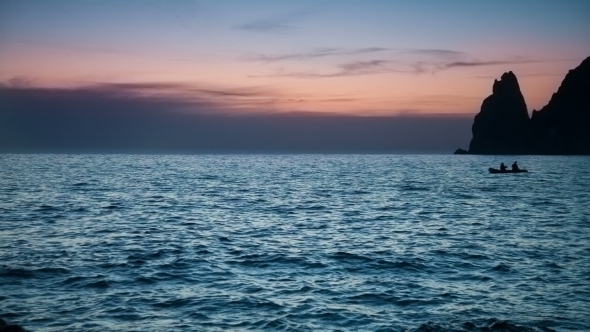 Boat Sails On The Sea At Dusk