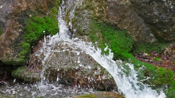 Water Flowing Over Rocks And Moss