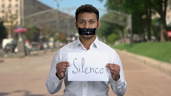 Censored Man with Black Tape Over Mouth Outdoor