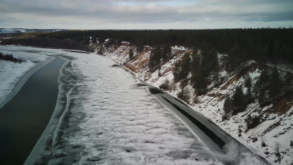 Calm Frozen River Covered with Ice on Cold Winter Day