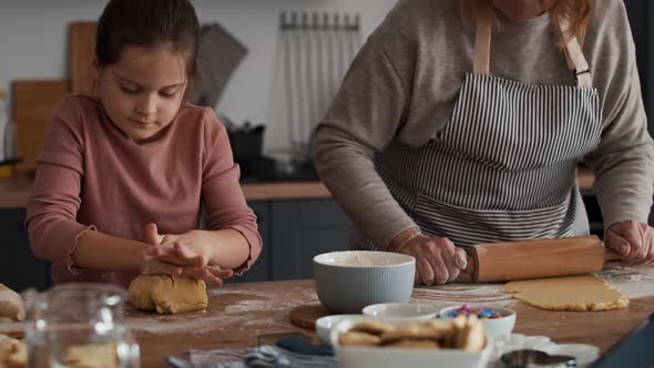 Caucasian girl baking cookies with grandmother. Shot with RED helium camera in 8K