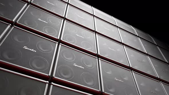 Playing cabinet speakers stacked on a stage in form of an endless wall pattern.