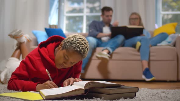 Diverse Roommates Studying and Preparing for Exam in Common Living Room in Dorm