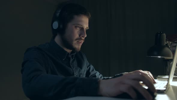 Man is Playing Emotional on Table at Home in Night