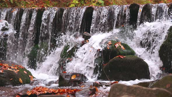 Large Boulders Overgrown with Moss at Waterfall