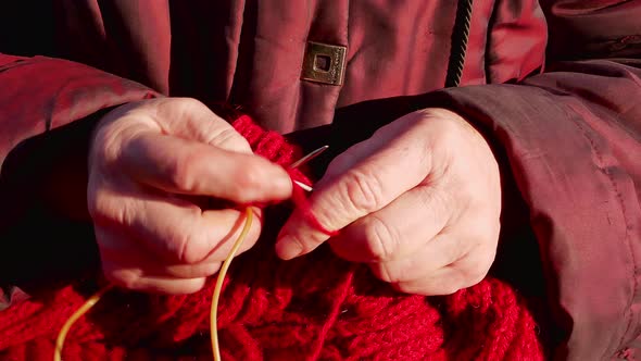 Knitting with woolen thread for warm clothes.