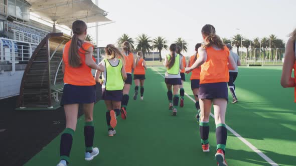 Female hockey players warming up in stands