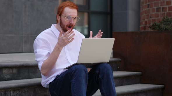 Wondering Designer Using Laptop while Sitting on Stairs Outside Office