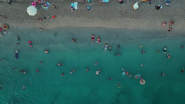 People swim in the evening sea aerial view 4 K Turkey Alanya