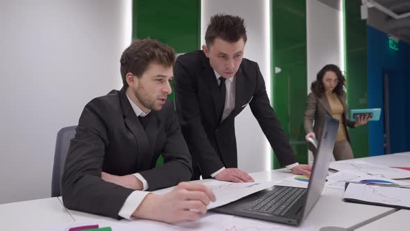 Focused Caucasian Busy Men Talking Analyzing Emarket As Woman Entering Conference Room