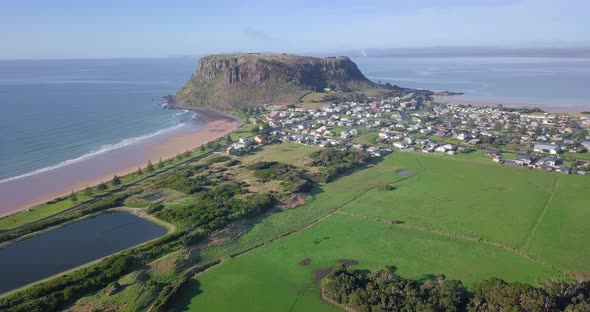 Aerial flight over Stanley with huge rock in background in Tasmania, Australia