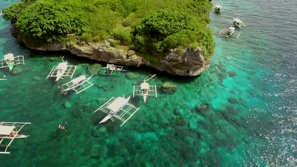 Aerial view of Pescador Island with traditional filipino boats, Philippines.