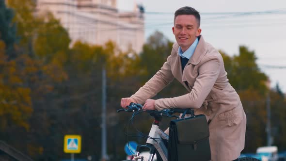 Successful businessman on bicycle outside