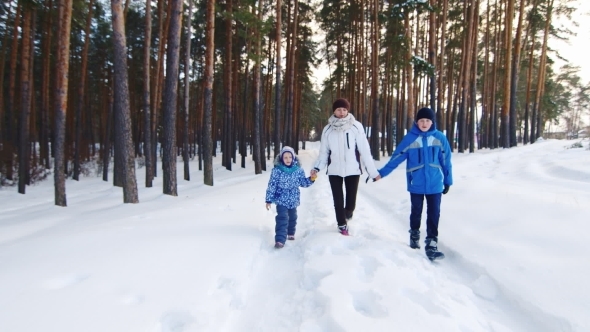 Happy Woman With Two Children Goes On Winter Road