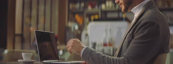 Handsome businessman working in cafe