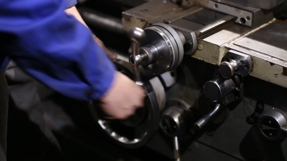 Operator Turns The Handle To Move The Cutter